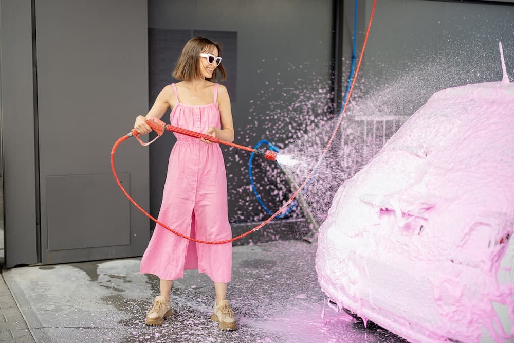 woman-in-pink-dress-washing-her-tiny-car-with-nano-2022-06-27-14-49-03-utc.jpg